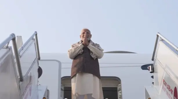 Prime Minister Narendra Modi greets as he emplanes for Kuwait