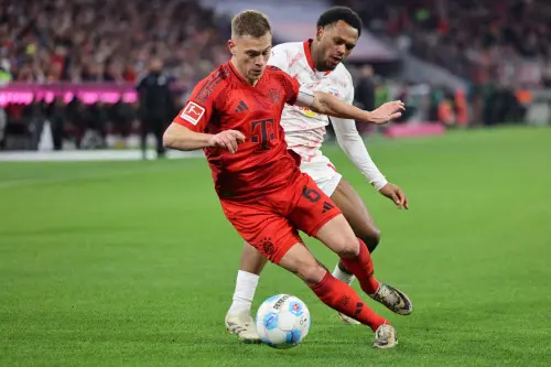 Bayern Munich's German midfielder   Joshua Kimmich and Leipzig's Belgian forward  Lois Openda vie for the ball during the German first division Bundesliga football match between FC Bayern Munich and RB Leipzig in Munich, southern Germany, on December 20, 2024. | Photo:  AFP