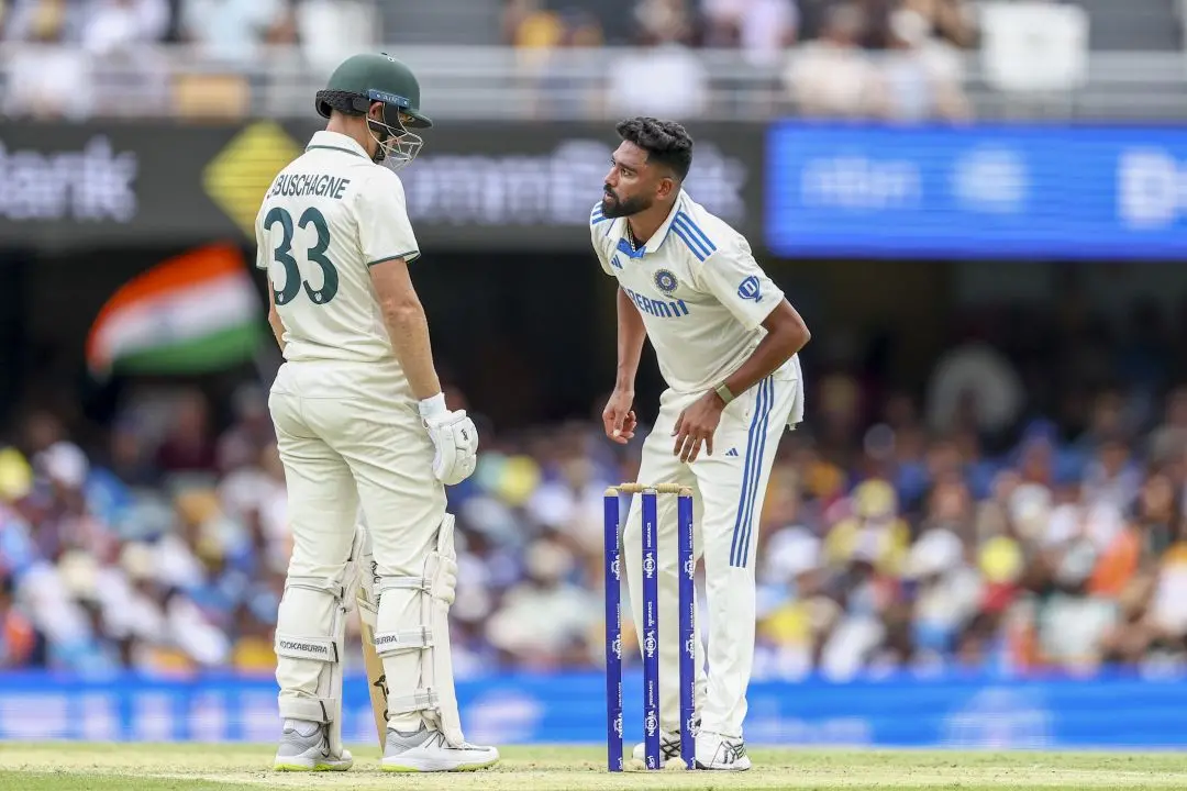 Mohammed Siraj, right, talks to Australia's Marnus Labuschagne during play on day two of the third cricket test between India and Australia at the Gabba in Brisbane, Australia