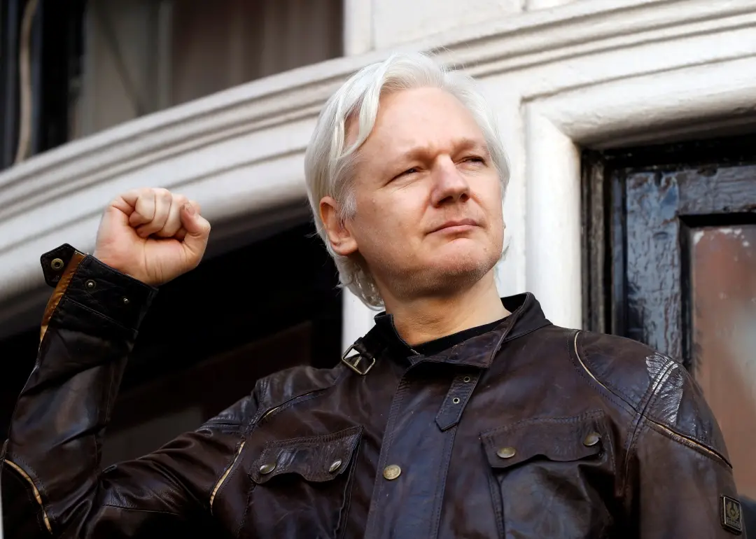Julian Assange greets supporters outside Ecuadorian embassy in London in 2017 | File photo: AP