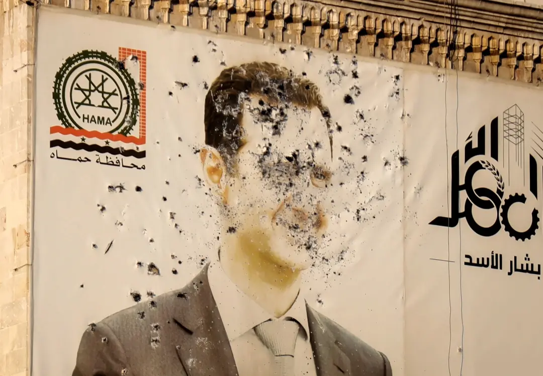 An image of Syrian President Bashar Assad, riddled with bullets | Photo: AP