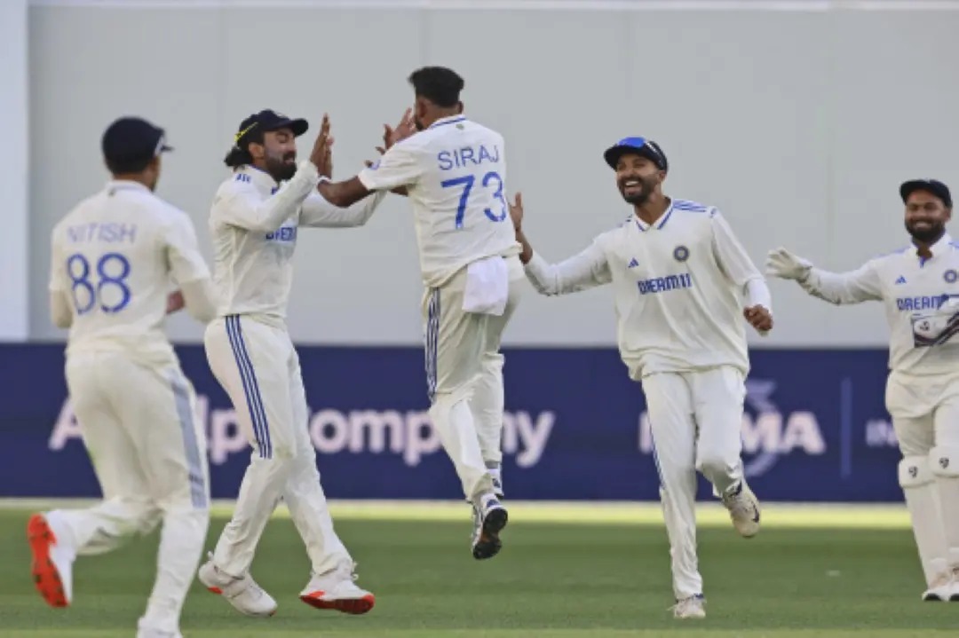 India's Mohammed Siraj, center, back to the camera, celebrates with teammate KL Rahul the wicket of Australia's Marnus Labuschagne on the first day of the first cricket test between Australia and India in Perth. | Photo: AP