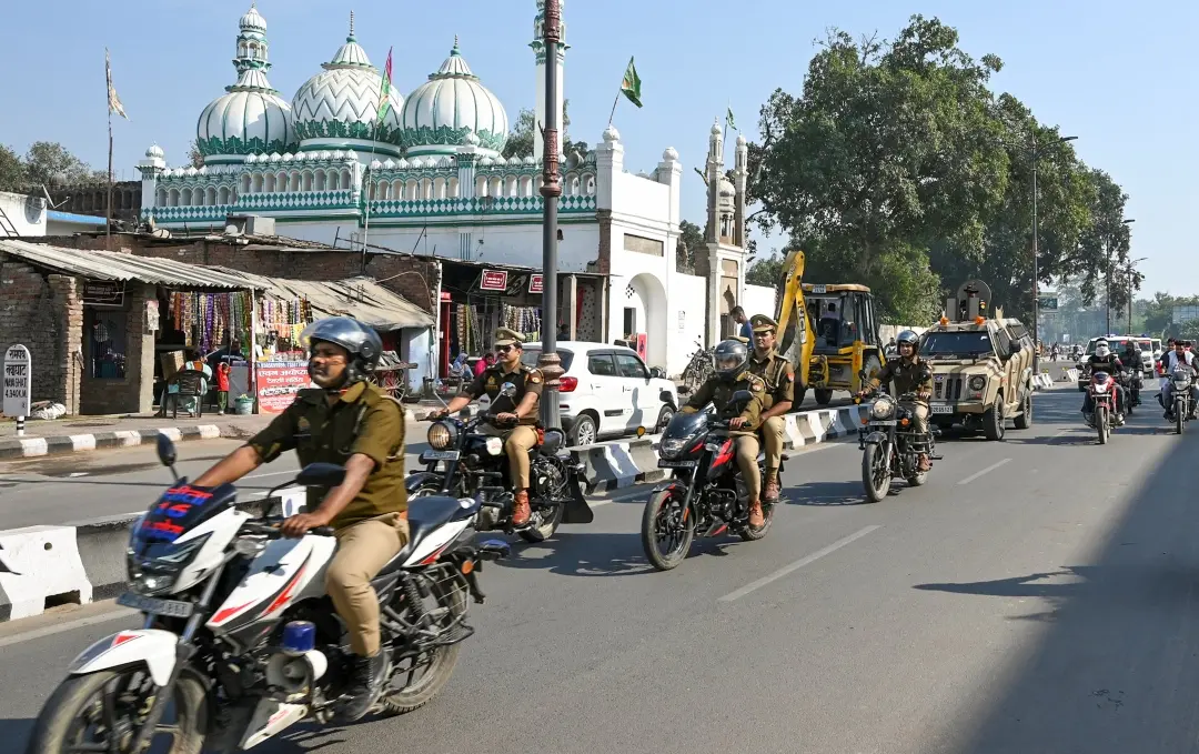 Police convoy patrols an area amid tight security on the Babri Masjid demolition anniversary, in Ayodhya on Friday, December 6, 2024.