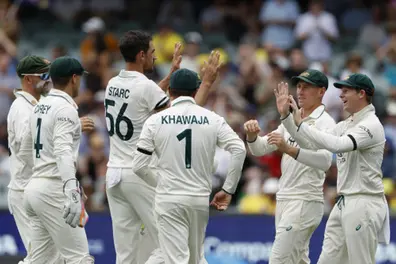Australian players wear black armbands in memory of Hughes and Redpath