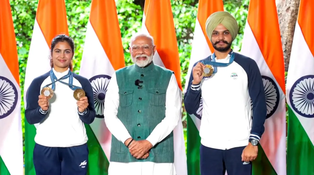 Prime Minister Narendra Modi with bronze medallist shooters Manu Bhaker and Sarabjot Singh during his interaction with the Indian contingent for Paris Olympics in New Delhi | Photo: PTI