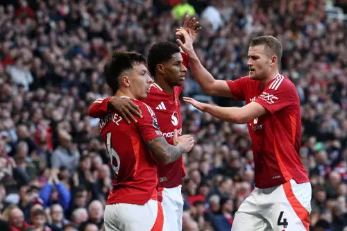 Manchester United's English striker Marcus Rashford (C) celebrates with Manchester United's Argentinian defender Lisandro Martinez (L) and Manchester United's Dutch defender Matthijs de Ligt (R) after scoring the opening goal of the English Premier League football match between Manchester United and Everton at Old Trafford in Manchester, north west England, on December 1 | Photo : AFP