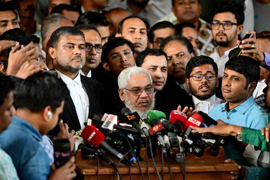 Defense lawyer S M Shahjahan (C) addresses media at the Bangladesh High Court in Dhaka on Sunday, December 1, 2024, after a verdict over a 2004 grenade attack case acquitted all the accused, including Bangladesh Nationalist Party (BNP) vice-chairman Tarique Rahman and former home minister Lutfozzaman Babar.