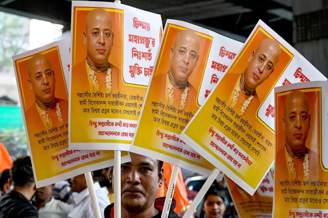 A Bharatiya Janata Party (BJP) worker holds placards of Chinmoy Krishna Das Brahmachari, a Bangladeshi jailed Hindu monk leader, member of the Bangladesh Sammilito Sanatan Jagaran Jote group and former member of ISKCON, during a protest to condemn his arrest, in Kolkata on November 27