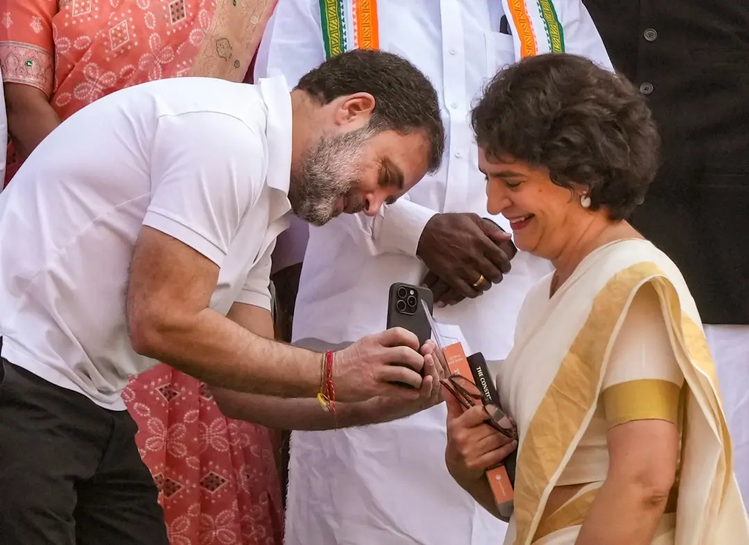 Rahul Gandhi takes pictures of Priyanka Gandhi after she took oath as a Lok Sabha MP from Wayanad on Thursday | Photo: PTI