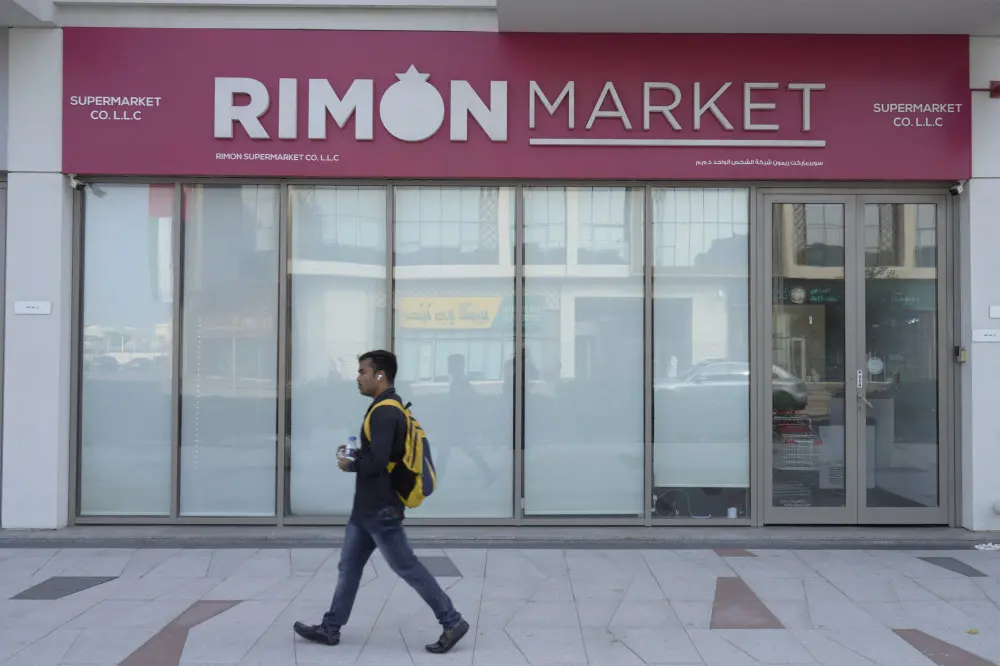 A man walks past Rimon Market, a Kosher grocery store managed by the late Rabbi Zvi Kogan | Photo: AP