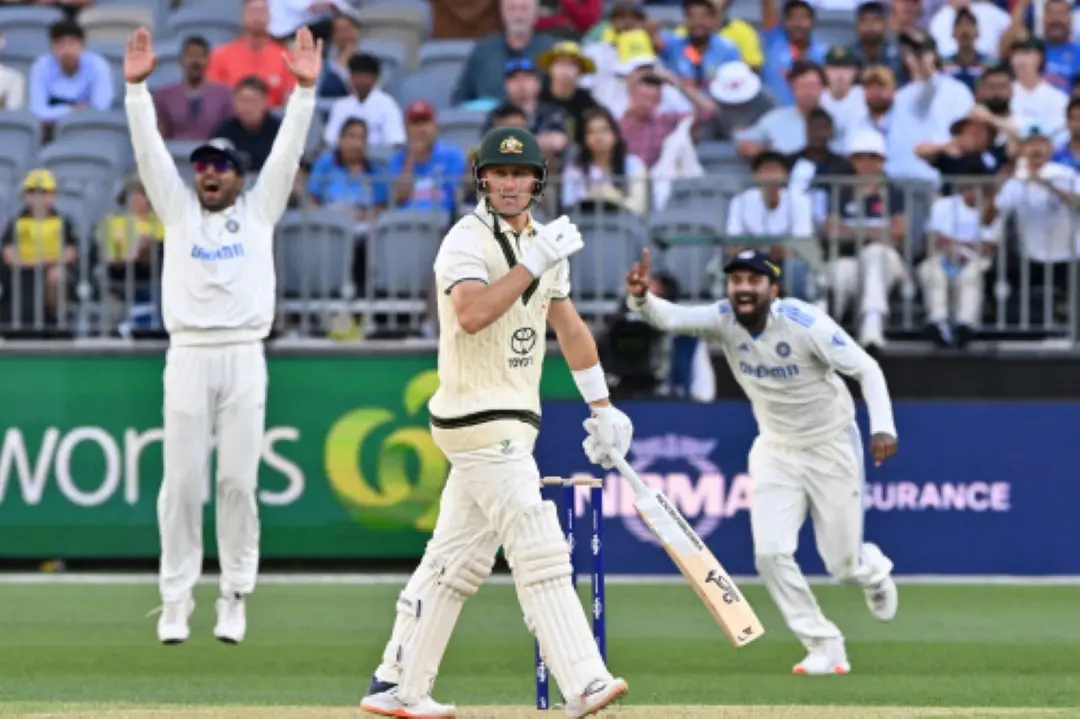 Australia's Marnus Labuschagne (C) walks off after his dismissal during the first day of the first Test cricket match between Australia and India at the Optus Stadium in Perth. | Photo: AFP