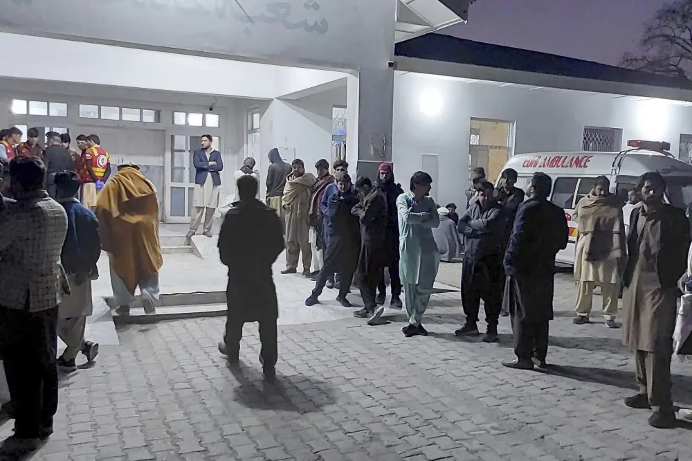 Local residents and volunteers gather and wait for the arrival of victims of gunmen firing incident on passenger vehicles | AP
