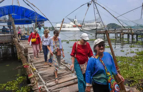 Foreign tourists after visiting the Chinese Fishing Nets in Kochi. l File Photo: PTI
