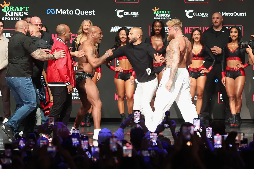 Mike Tyson and Jake Paul are separated as they face off during their ceremonial weigh-in at The Pavilion at Toyota Music Factory | Getty Images via AFP