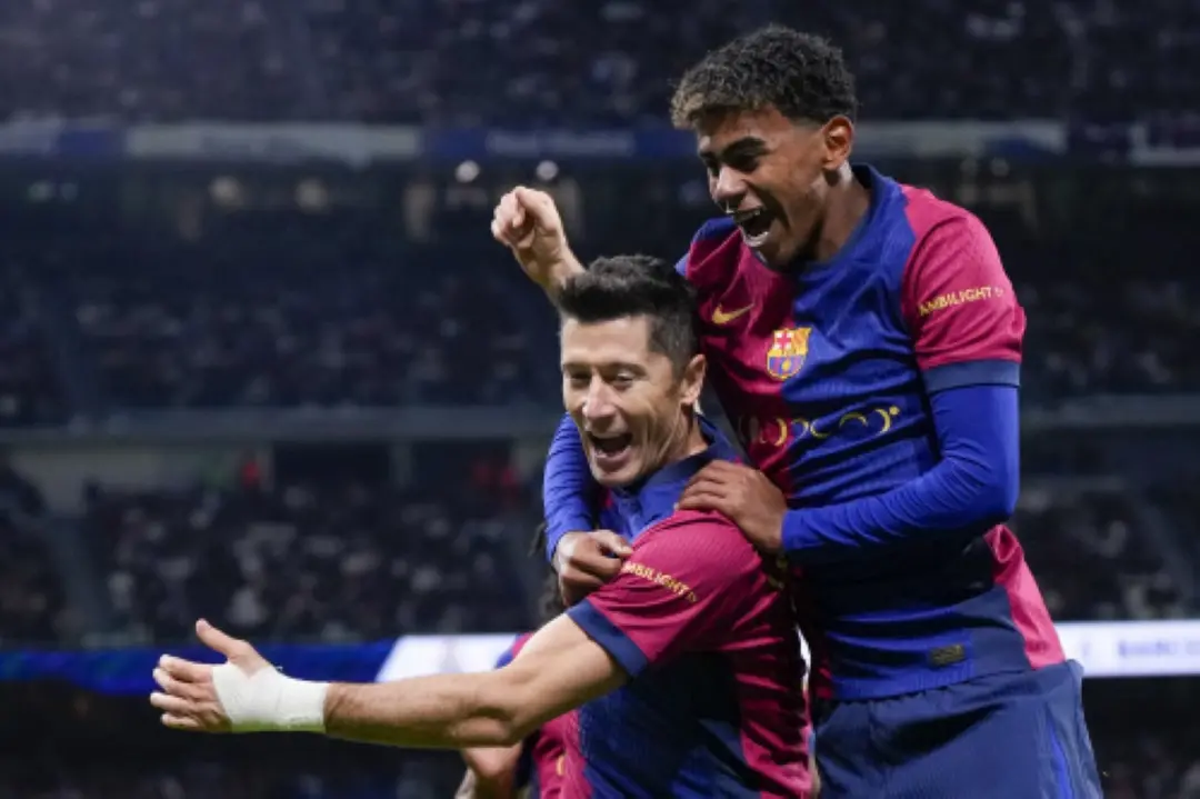 Barcelona's Robert Lewandowski celebrates after scoring his side's second goal with Barcelona's Lamine Yamal, right, during a Spanish La Liga soccer match between Real Madrid and Barcelona at the Santiago Bernabeu stadium in Madrid. | File Photo: AP