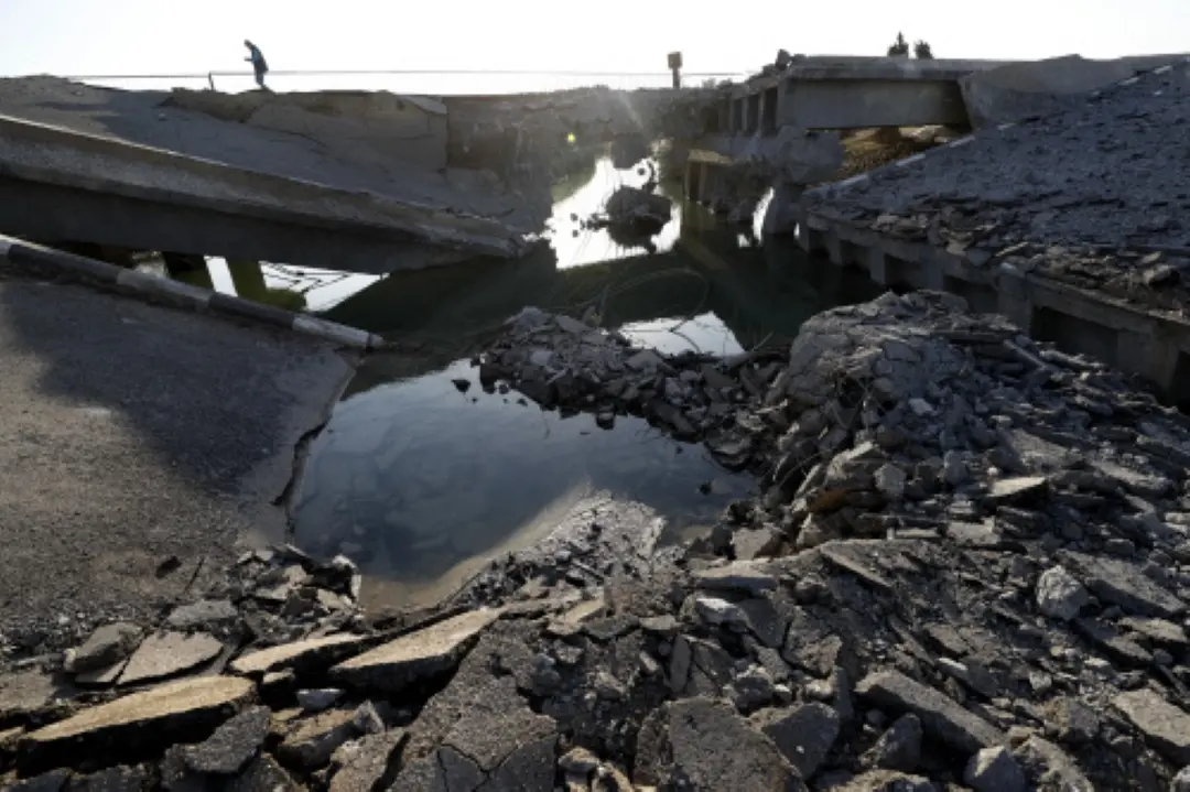 A Syrian man passes by a bridge that links to Lebanon which was destroyed on Oct. 24 by an Israeli airstrike, in Qusair, Syria. | File Photo: AP