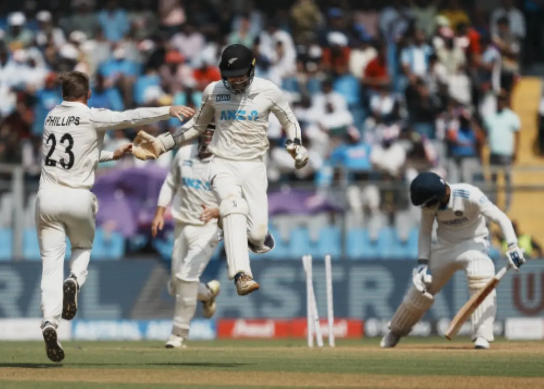 New Zealand's Glenn Philips with teammates celebrates the wicket of India's Akash Deep during day three of third Test cricket match between India and New Zealand at Wankhede Stadium in Mumbai. | Photo: PTI