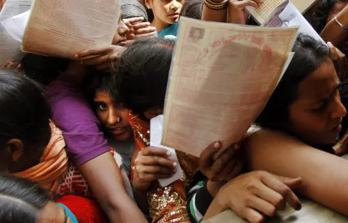 Unemployed Indians crowd outside the Employment Exchange Office | AP