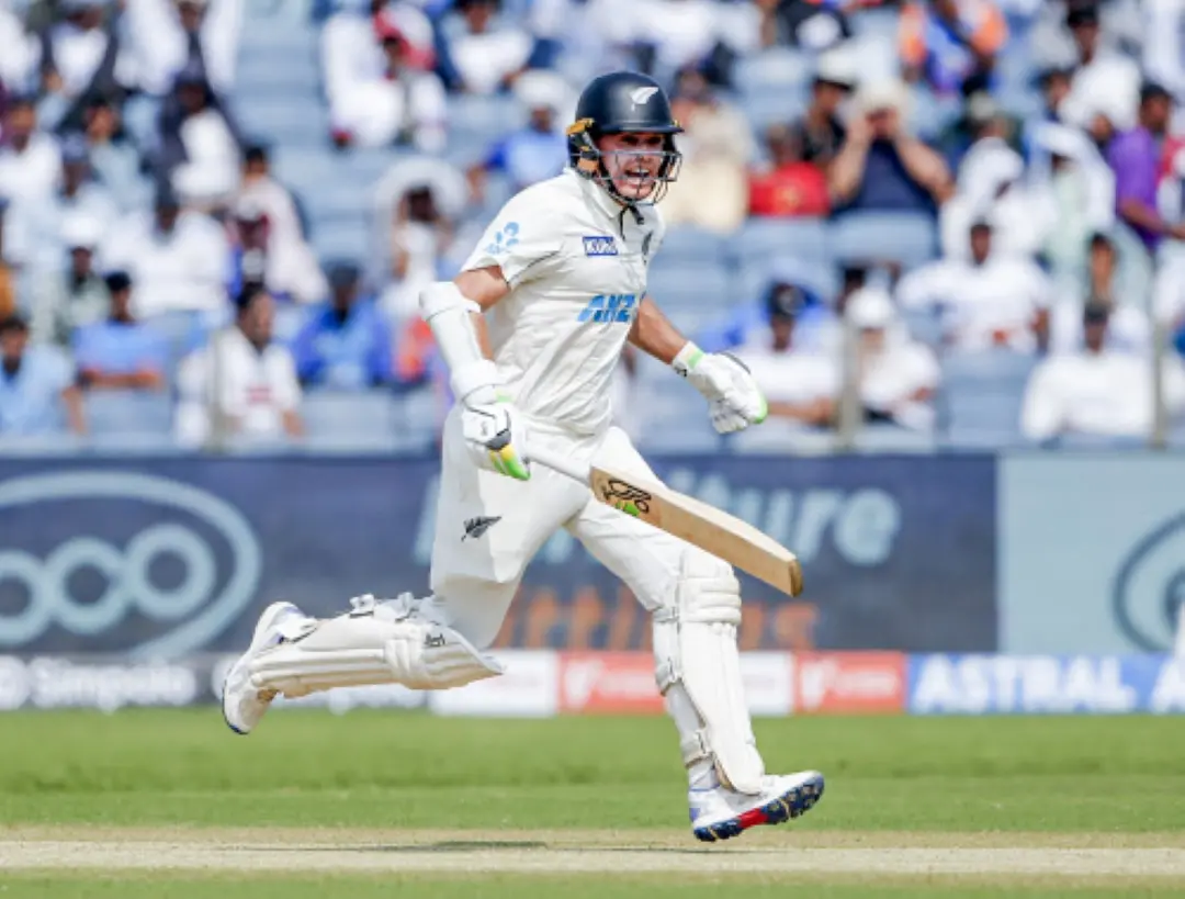 New Zealand's Captain Tom Latham celebrates his half-century during Day 2 of the second test match against India, at Maharashtra Cricket Association Stadium in Pune.