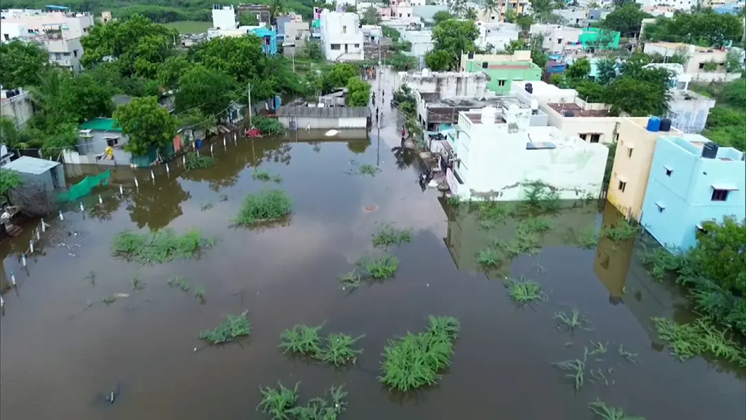 Water from the overflowing Pandalkudi canal enters residential areas leading to severe flooding following heavy rain, at Karisalkulam in Madurai on Wednesday | Photo: ANI