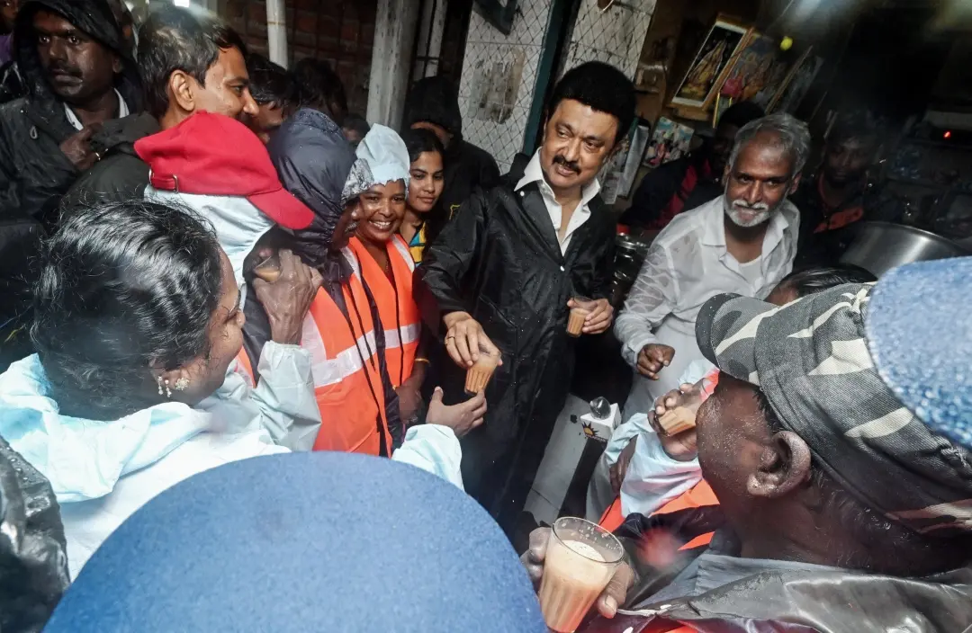 Tamil Nadu Chief Minister MK Stalin distributes tea to sanitation workers after inspecting the unhindered flow of rainwater in the Otteri Canal amid heavy rains, at Pulianthope in Chennai on Tuesday | Photo: ANI