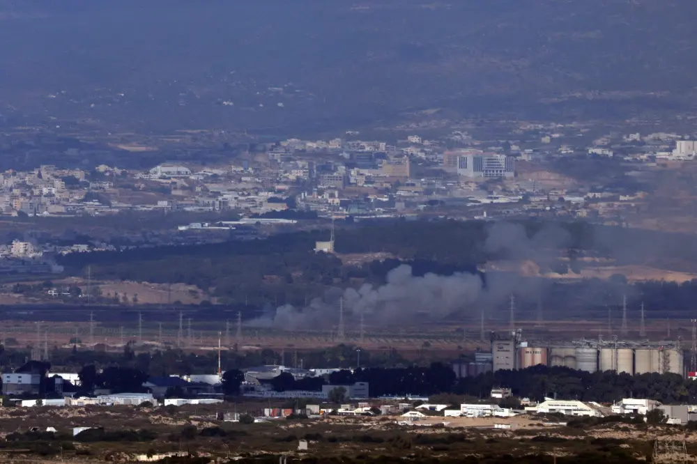 This picture taken from the northern Israeli port city of Haifa shows smoke billowing near the northern Israeli city of Tamra on Oct 12 | AFP