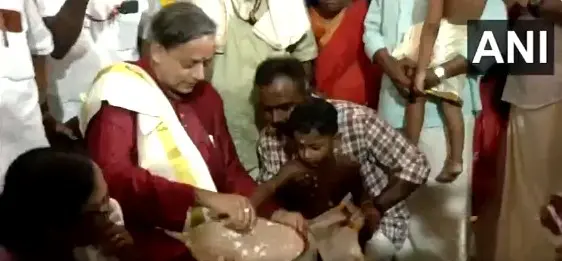Congress MP Shashi Tharoor helps a young child write his first letters on a rice platter | Photo: Screengrab of X / ANI