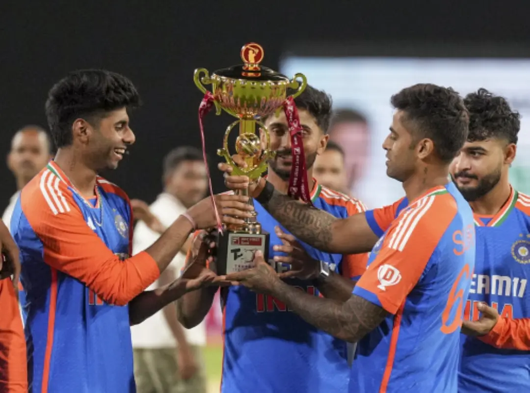 India's captain Suryakumar Yadav hands over the championship trophy to teammates during the presentation ceremony after winning the third and final T20 International cricket match between India and Bangladesh at the Rajiv Gandhi International Cricket Stadium, in Hyderabad. | Photo: PTI