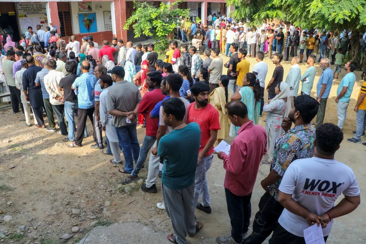 People wait in queues to cast their votes at a polling booth during the third and final phase of Jammu & Kashmir Assembly elections, in Jammu | Photo: PTI