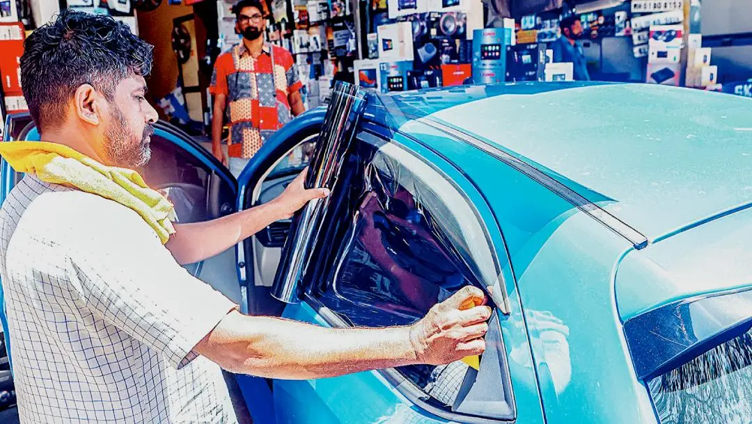With the recent permission to apply sun film on vehicles, the installation of sun film on cars is now actively taking place at Kozhikode YMCA | Photo: Mathrubhumi