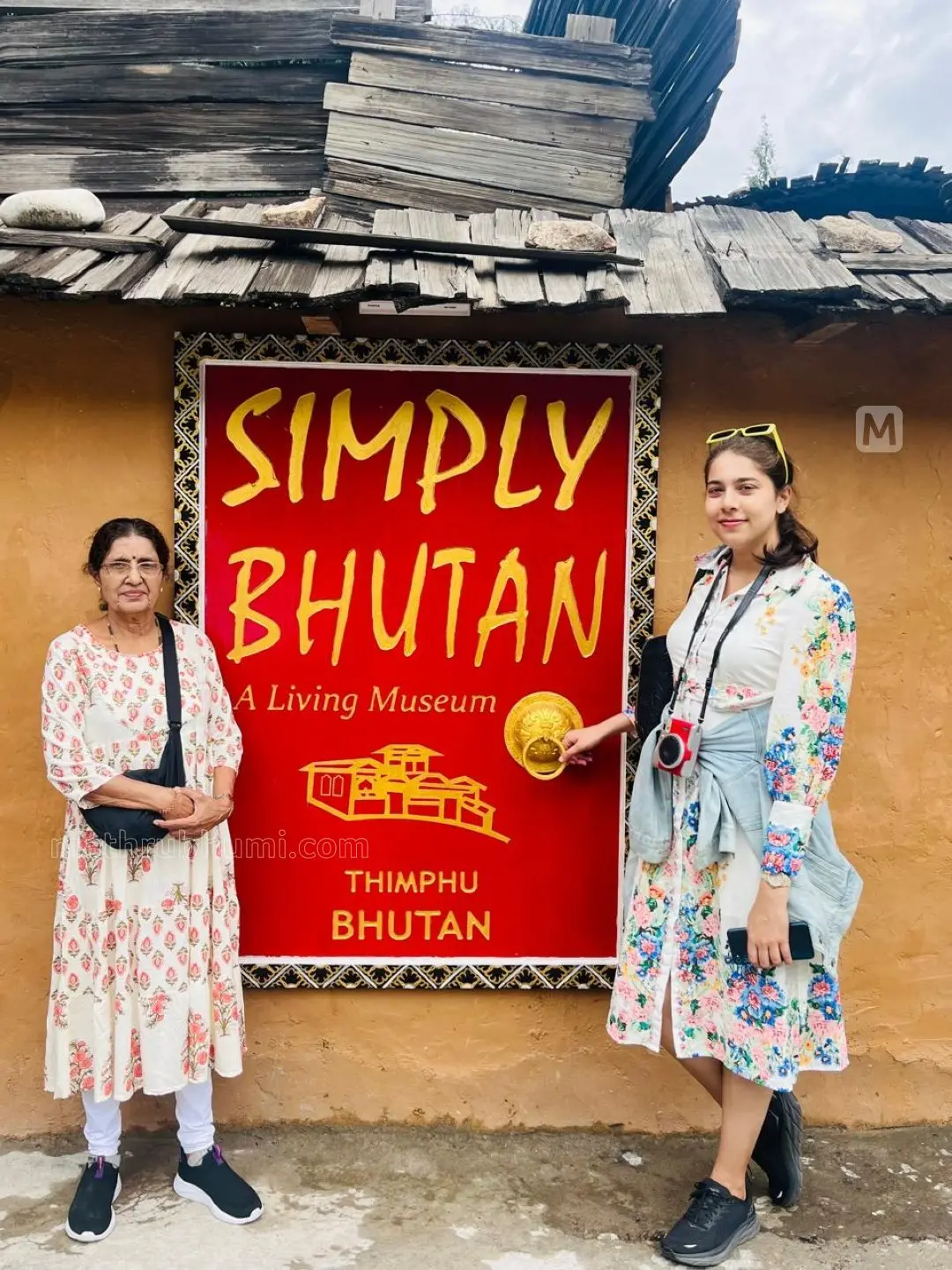 Tourists pose in front of the museum