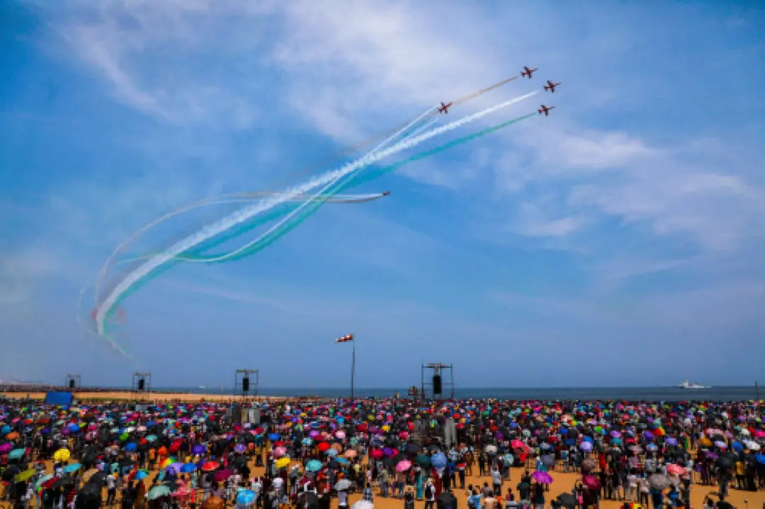 A crowd witness the Indian Air Force fighter jets forming a tricolour during the rehearsal of an air show ahead of Indian Air Force (IAF) Day, at Marina Beach in Chennai on Sunday. (ANI Photo)