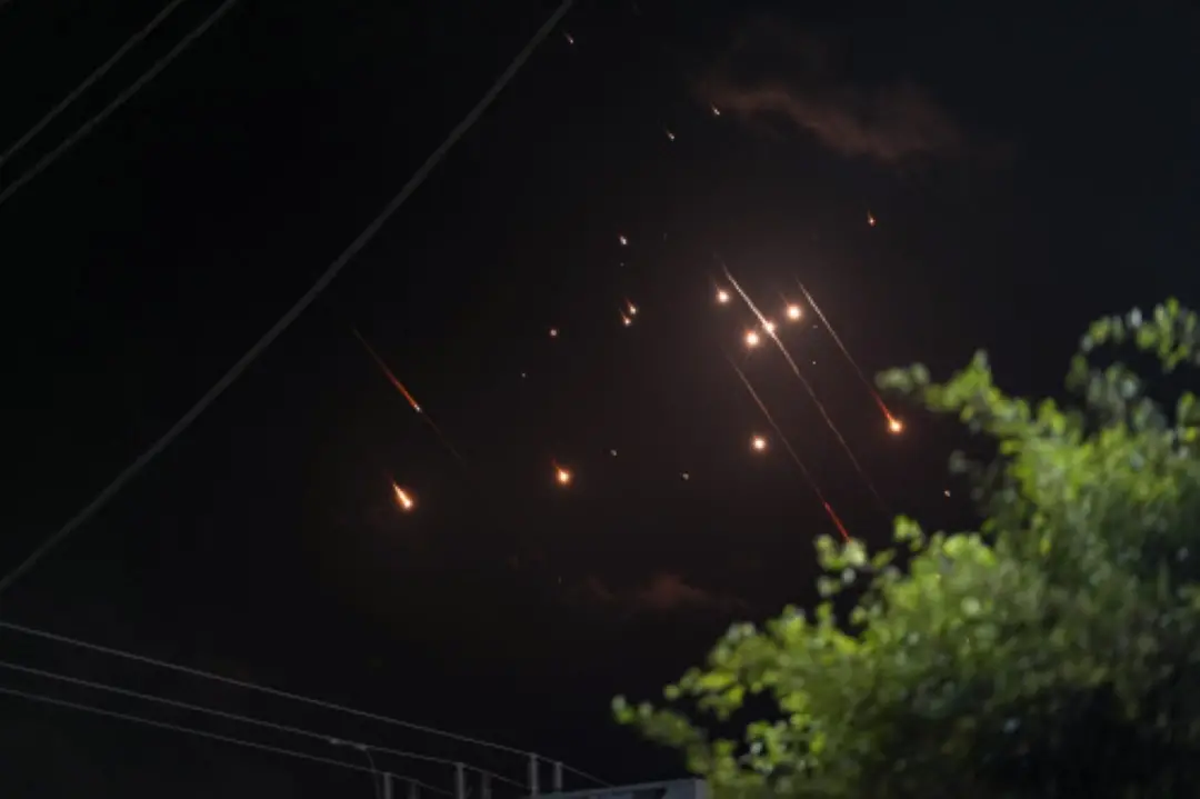 Missiles launched from Iran towards Israel streak across the night sky as seen from Deir al-Balah, Gaza Strip, on Tuesday. | Photo: AP/PTI
