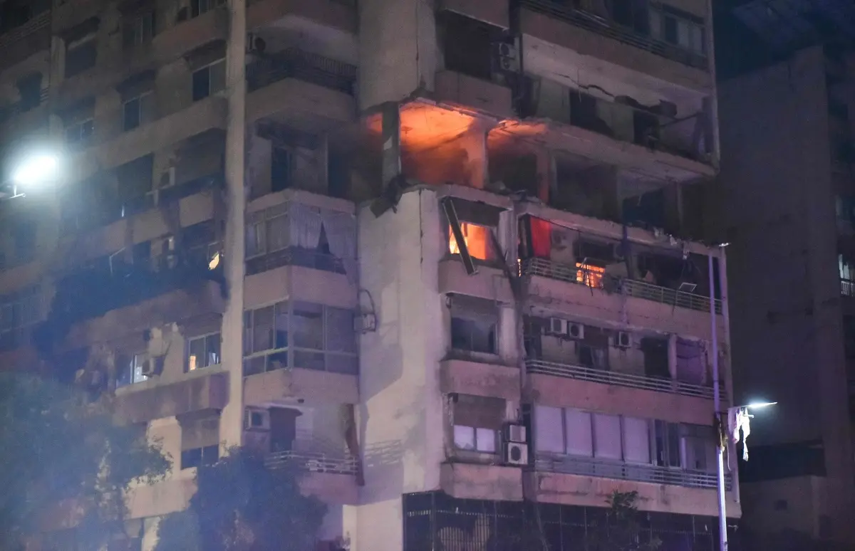 Fire sweeps through an apartment building hit by an Israeli air strike in Beirut | Photo: AFP