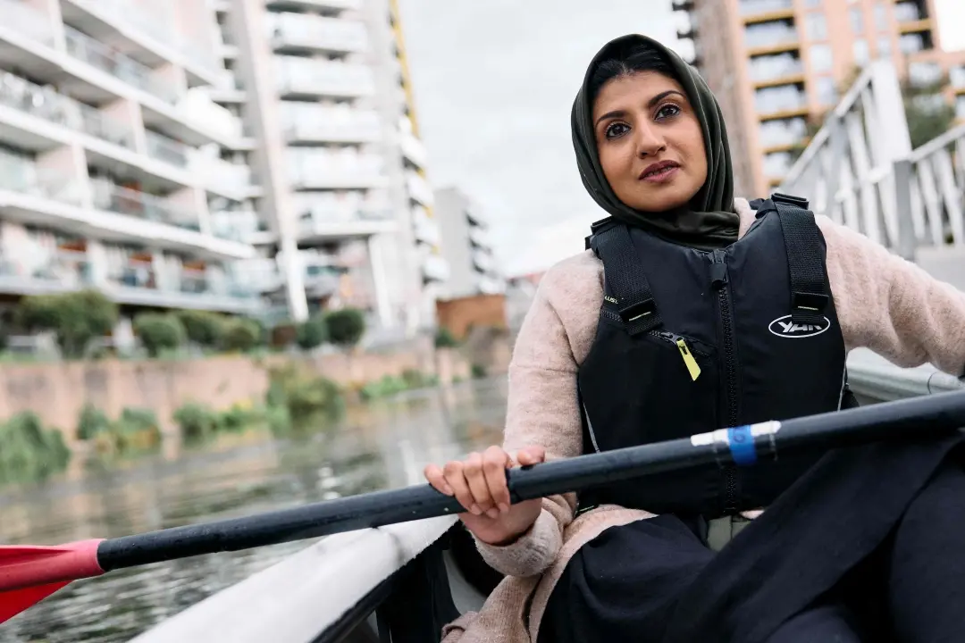 Qualified paddle sport instructor Dilruba Begum poses for a photograph during a stand up paddleboard and kayak instructing session at Limehouse Cut canal in east London | Photo: AFP