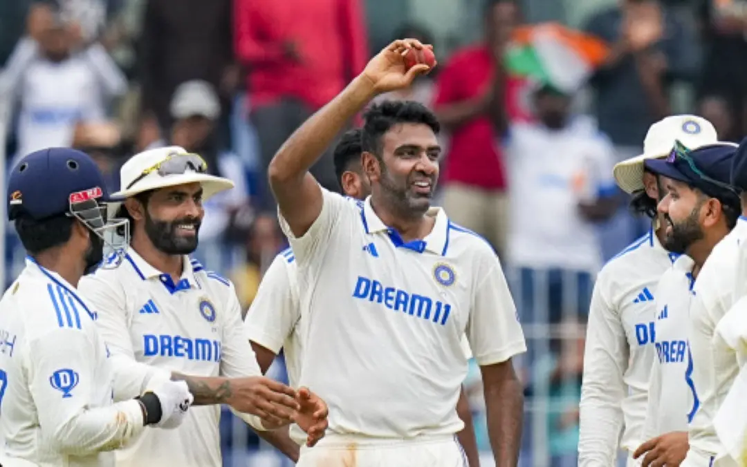 Ravichandran Ashwin with teammates shows the ball after taking 5 wickets on the fourth day of the first Test cricket match between India and Bangladesh at M. A. Chidambaram Stadium, in Chennai on Sunday. | | Photo: PTI