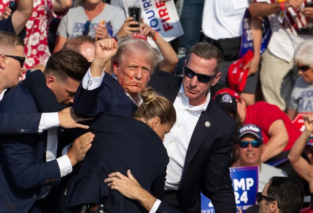 Secret Service agents surround Republican presidential candidate former President Donald Trump onstage after he was injured at a rally in Pennsylvania