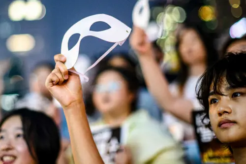 An activist holds an eye mask during a protest against deepfake porn in Seoul | Photo: AFP