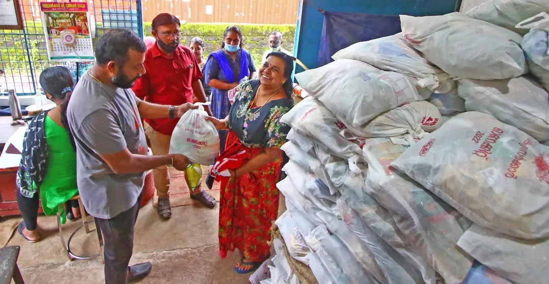 A woman collecting the free onam food grains kit from a ration shop at Kannur | File photo: Ridhin Damu