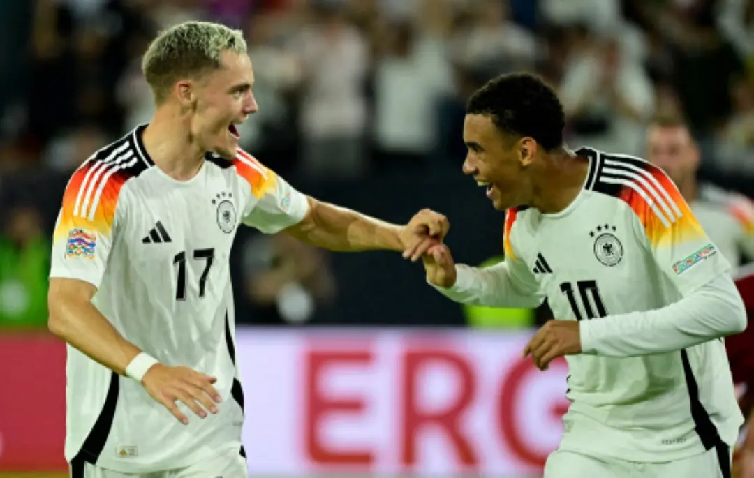 Germany's midfielder #17 Florian Wirtz (L) and Germany's midfielder #10 Jamal Musiala celebrate after Wirtz scored the 3-0 goal during the League A Group A3 football match of the UEFA Nations League between Germany and Hungary in in Duesseldorf, western Germany. | Photo: AFP