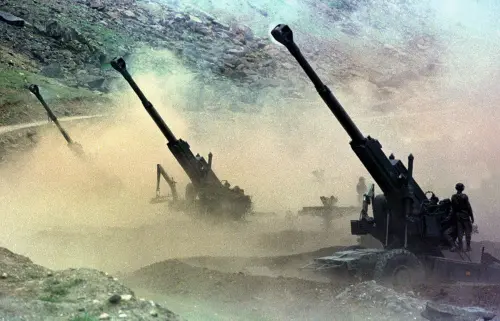 A file photo shows Indian artillery men firing 155mm Bofors guns at enemy positions from a gun emplacement in the Drass sector of Indian-controlled Kashmir.