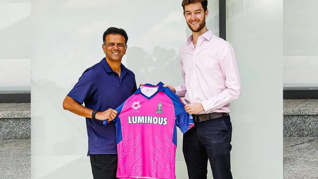 Former cricketer Rahul Dravid receives his pink jersey from Royals Sports Group CEO Jake Lush McCrum after the former joined the IPL franchise Rajasthan Royals as head coach. | Photo: X