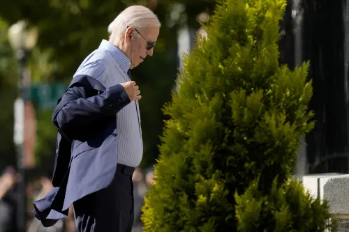 President Joe Biden puts his jacket on as he arrives at Holy Trinity Catholic Church in the Georgetown section of Washington, to attend Mass, Saturday, July 22, 2023. (AP Photo/Manuel Balce Ceneta)