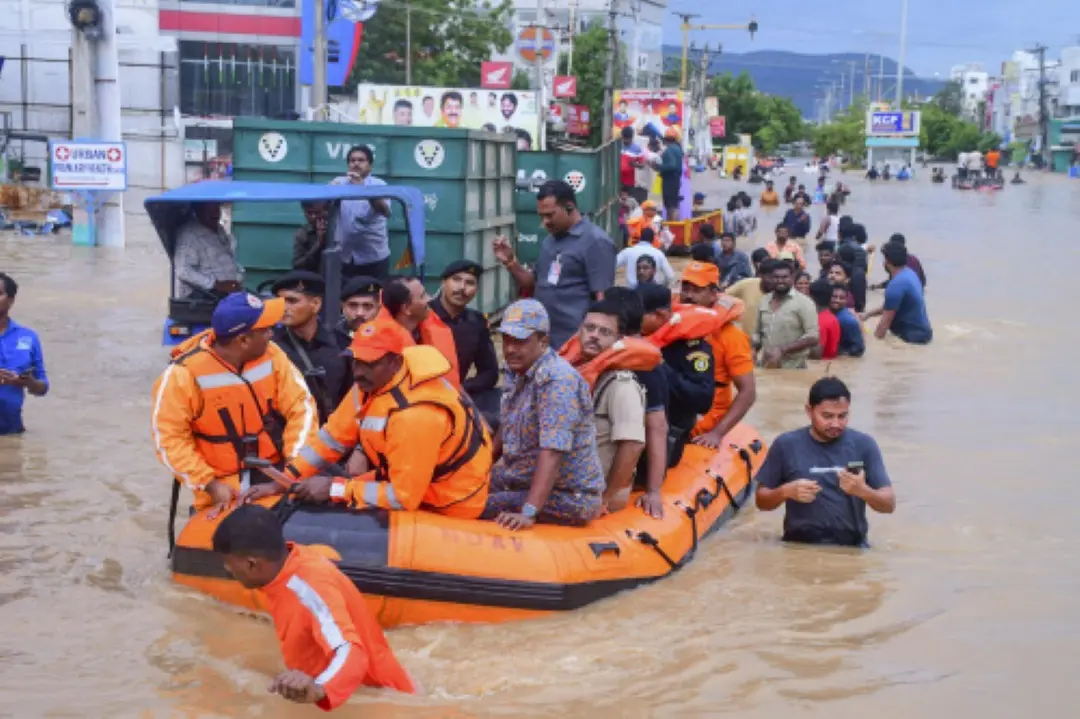 Vijayawada City Police Commissioner IPS SV Rajasekhara Babu with others reviews the rescue operation at a flood-affected area after heavy rainfall, in Vijayawada. | PTI Photo