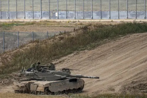 Israeli soldiers rest on top of their tank on the border with the Gaza Strip, in southern Israel on Monday. l Photo: AP