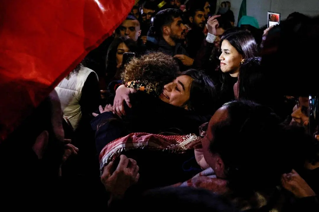A newly released Palestinian prisoner Rouba Assi hugs relatives during a welcome ceremony for prisoners freed from Israeli jails in exchange for Israeli hostages released by Hamas from the Gaza Strip