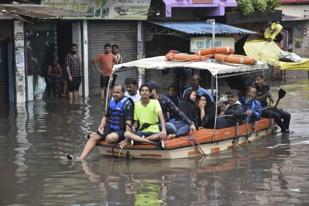 Residents being shifted from a flooded locality after heavy rains in Surat | Photo: PTI
