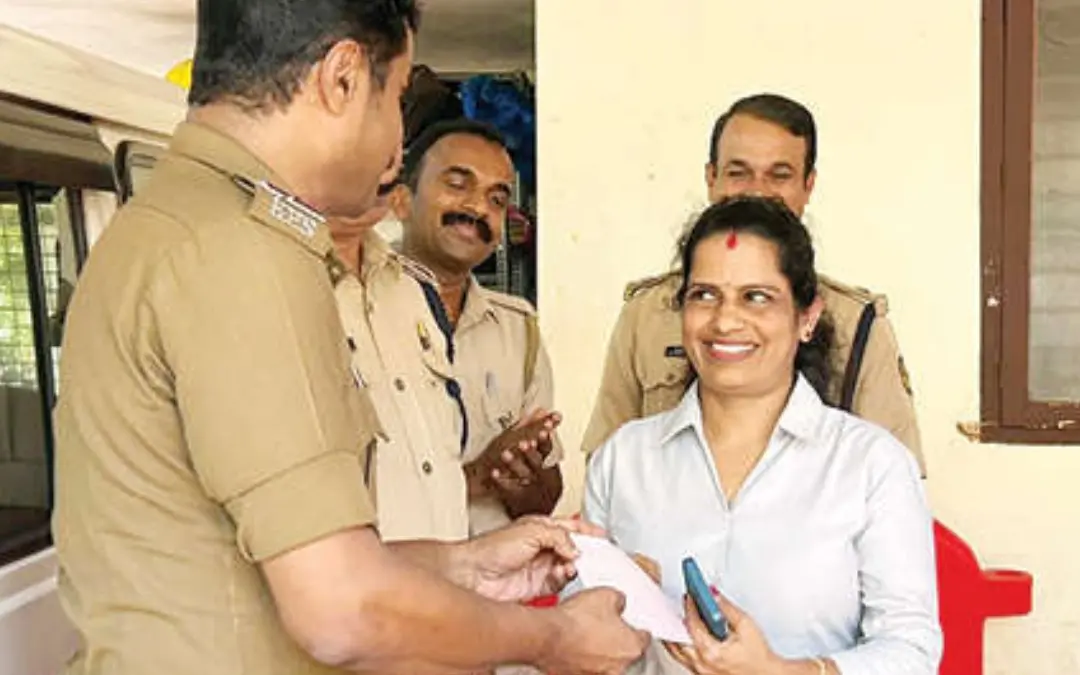 Inspector P. Ajithkumar hands over Rs 3,000 collected by Hosdurg station policemen to Chandrika