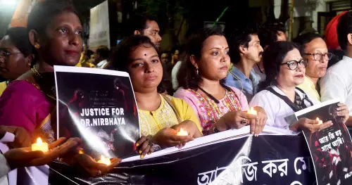 Union Minister of State and BJP state President Sukanta Majumdar, party leader Agnimitra Paul and others during a candlelight march for the victim of the RG Kar Medical College and Hospital murder case in Kolkata. | Photo: PTI