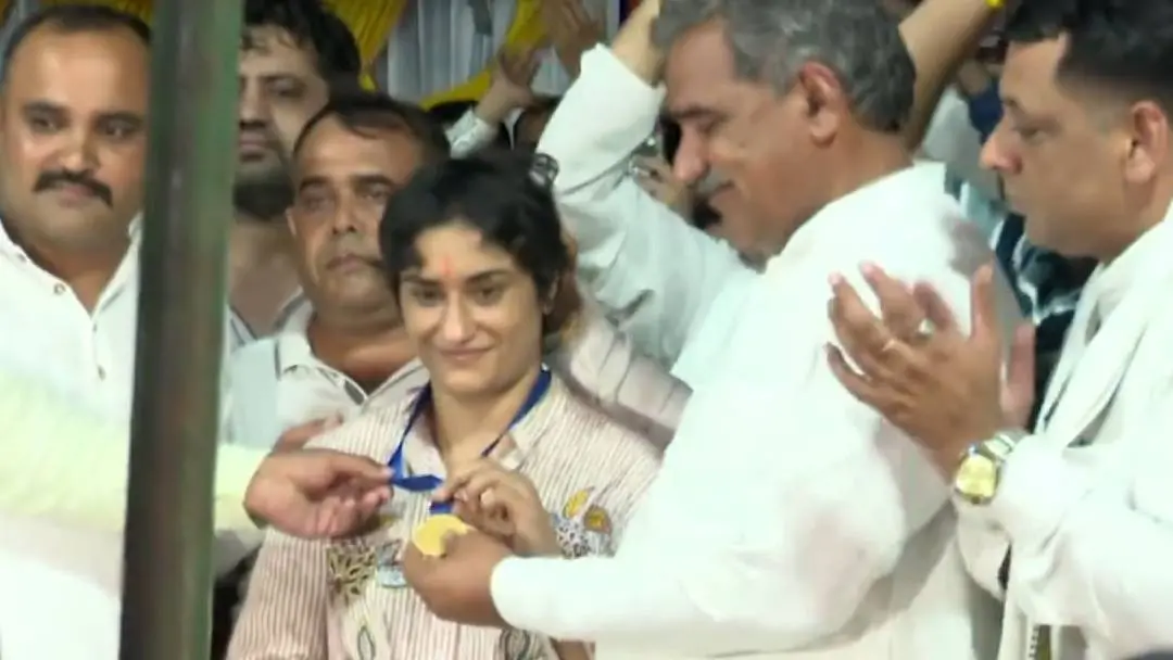 Vinesh Phogat being felicitated with a gold medal by community elders in her village in Haryana's Balali village. | Screengrab/X